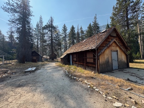 The boarded-up workshop and log cabins during the camp's long closure.