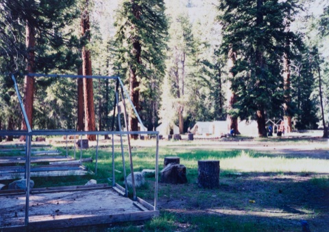 Bare tent-cabin frames waiting for canvas at season's start.