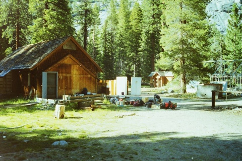 Furniture set out to air beside the open workshop door.