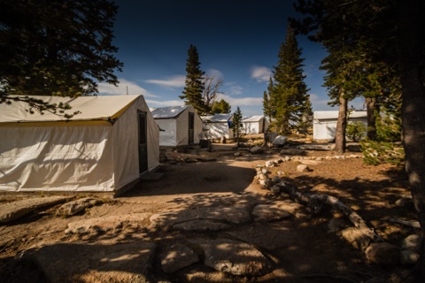 Guest tent cabins along the stone-lined path at the heart of camp.