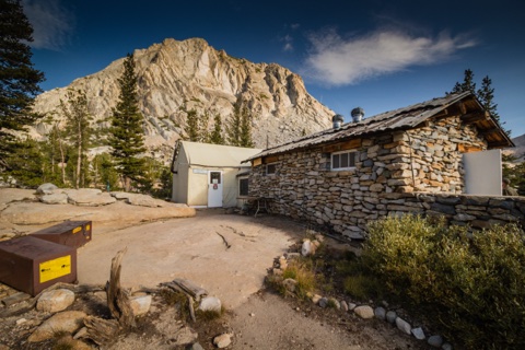 The dining hall's stonework, with Fletcher Peak rising behind.