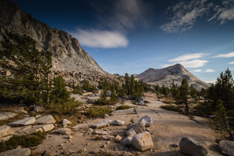Granite country above the camp — polished slabs, boulders, and scattered pines.