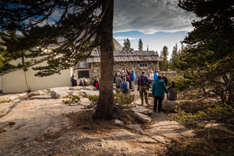 Guests gathering outside the stone dining hall.