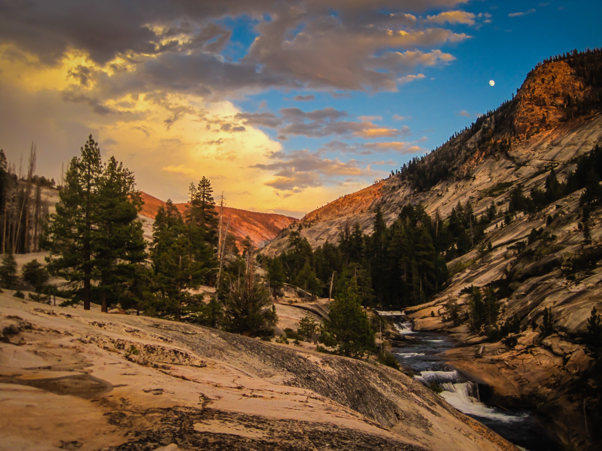 Sunset and a rising moon over a high granite canyon